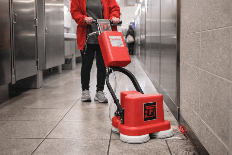 a custodian using the fas-edge in an airport bathroom.