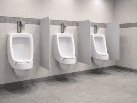 Your-In urinal splash control system installed in a commercial restroom to reduce odor and floor contamination